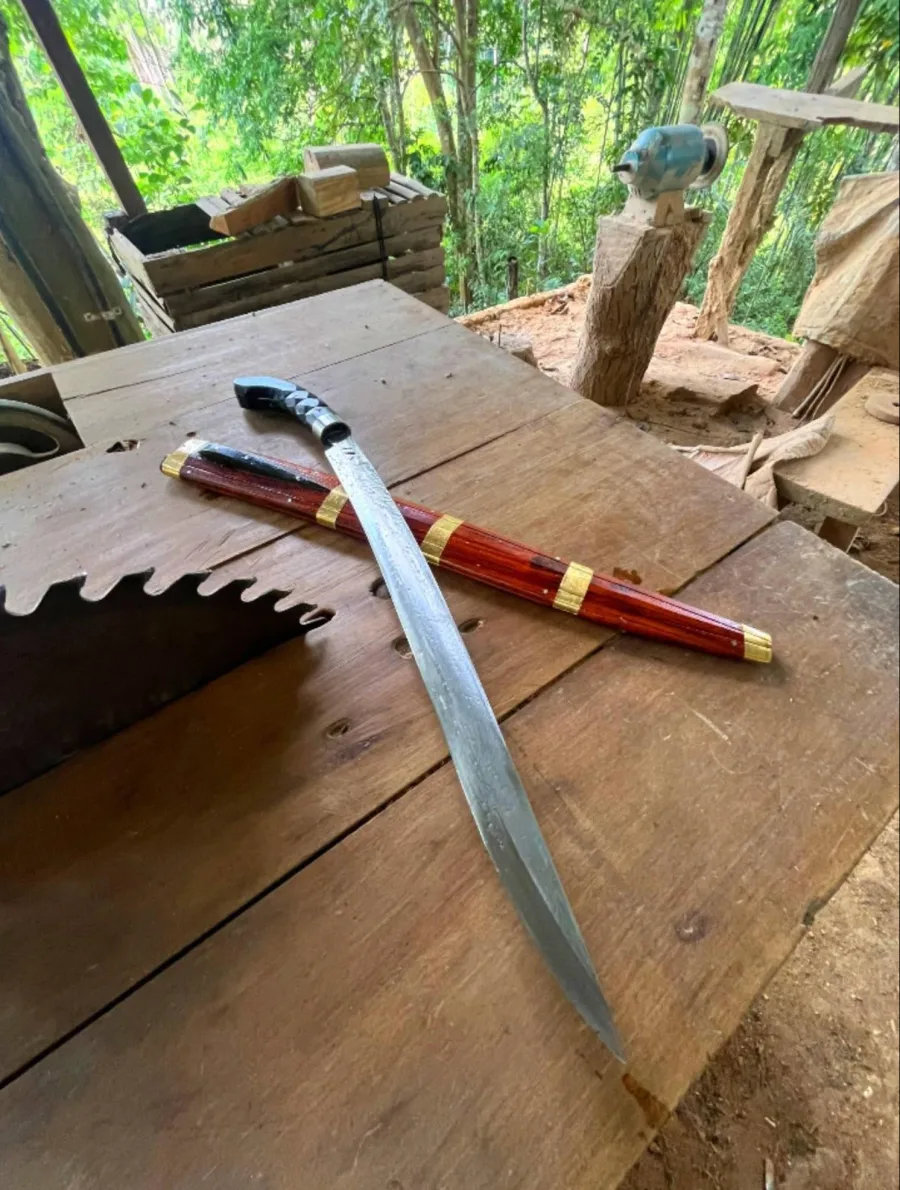 A long blade beside its brass-banded rosewood scabbard